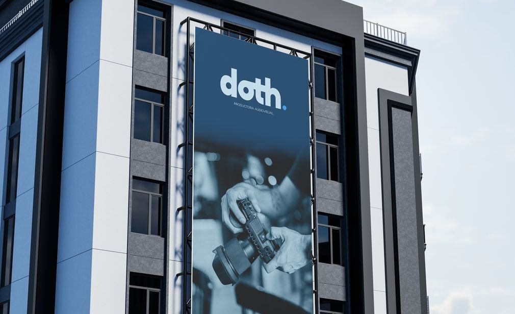 Fachada de un edificio con una valla que muestra el logo de DOTH